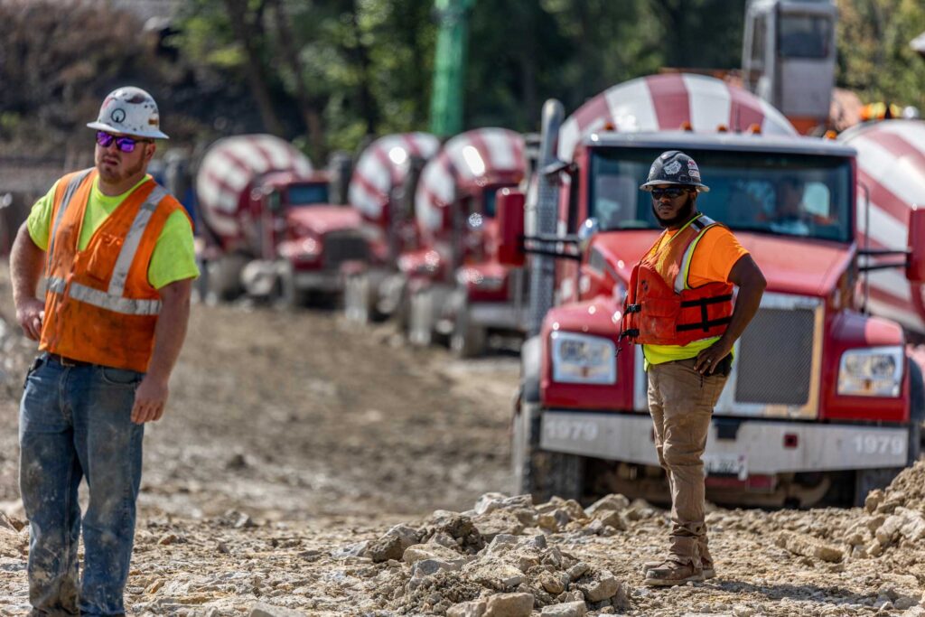 concrete trucks in line to deliver concrete